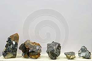 collection of various minerals on gray background : cassiterite stones