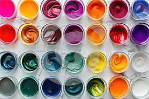 A collection of various paint colors arranged on top of a table, A variety of colourful and vibrant hair dye solutions in tubes