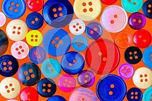 Collection of various sewing buttons on a red background