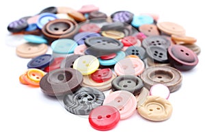 Collection of various sewing buttons on white background