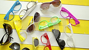 Collection of various style and color sunglasses and frames captured from above.