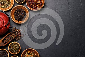 A collection of various teas nestled in wooden bowls