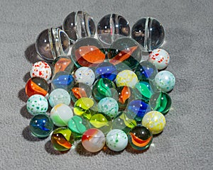 A collection of various types and sizes of marbles grouped together