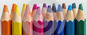 The collection of vibrant colored pencils arranged neatly in a row. AI generated image