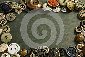 Collection of vintage clothing buttons. Dark stone background, grunge photo.