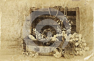 A collection of vintage jewelry in antique wooden jewelry box. retro filtered image. Old style photo.