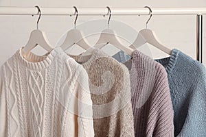 Collection of warm sweaters hanging