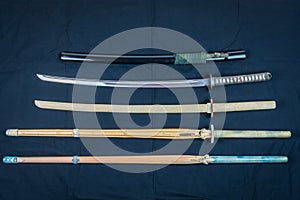 A collection of weapons for training, equipment for Japanese sport Iaido and Kendo. Wood, bamboo and steel sword .