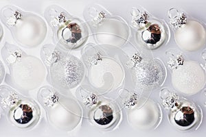 Collection of white and silver christmas balls in a box