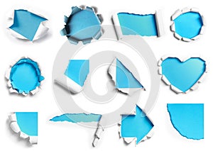 collection of white torn paper with blue background in many shape