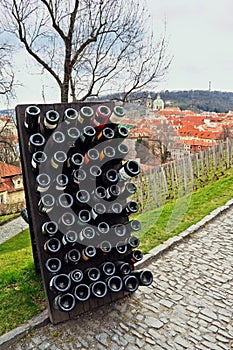 Collection wines aging in the rack outdoors against old town Prague