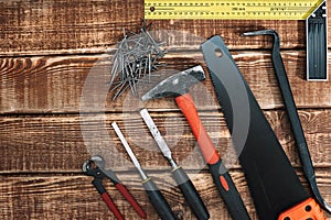 Collection of woodworking tools on a wooden background and copy space: carpentry, craftsmanship and handmade concept, flat lay.