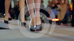 Collections shoes at fashion week, beautiful female legs in high heels on fashion show, stylish footwear on women feets
