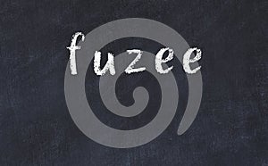 College chalk desk with the word fuzee written on in