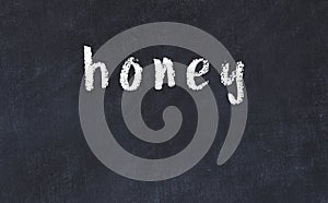 College chalk desk with the word honey written on in