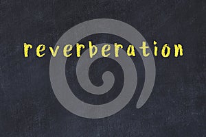 College chalk desk with the word reverberation written on in