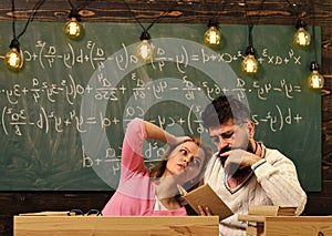 College and education concept. Girl student listening bearded teacher, lecturer, professor. Scientist reading, holds