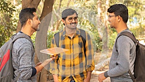 College friends socializing - Students talking with each other at university campus - Concept of happy college days and