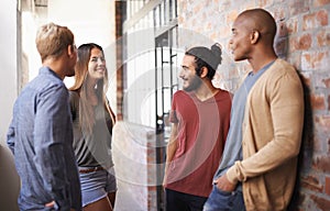 College, friends or students talking in a hallway for discussion, happiness or a chat. Group of diversity men and a