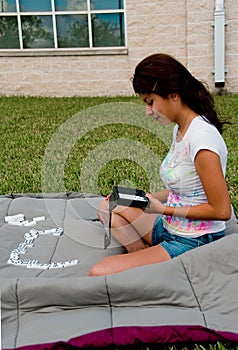 A college girl playing domino