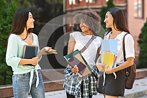 College Girlfriends. Portrait Of Smiling Female Students Chatting Outdoors After Classes