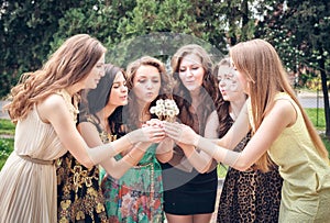 College Girls Blowing Dandelion Seeds