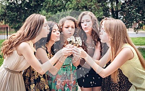 College Girls Blowing Dandelion Seeds