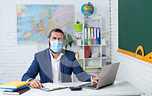 college lecturer on coronavirus pandemic. back to school. nonformal education. mature teacher wear respirator mask