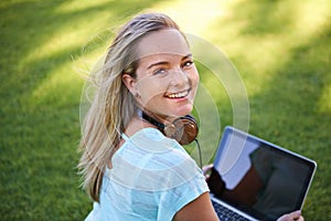 College, portrait and student with laptop on grass working on research outdoor in park. University, campus and happy