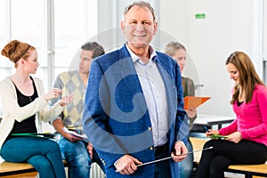 College professor in class with students photo