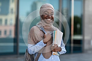 College Scholarships for Muslim Students. Happy Black Islamic Woman With Workbooks Outdoors