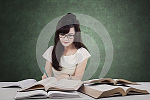 College student doing assignment in the class