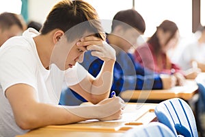 college student for exam in classroom