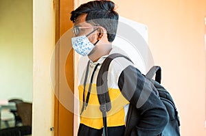 College student with face mask entering to classroom - concept of college reopen, new normal lifestyle after coronavirus or covid-