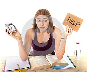 College student girl in stress asking for help holding alarm clock time exam concept