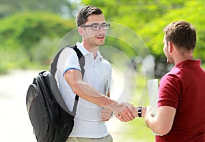 College student with glasses meet his friend at college park and