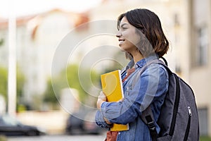 College Student. Happy Young Arab Woman With Backpack And Workbooks Standing Outdoors