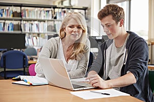 College Student Has Individual Tuition From Teacher In Library photo