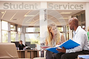 College Student Having Meeting With Tutor To Discuss Work