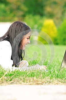 College student with laptop on the grass