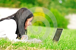 College student with laptop on the grass