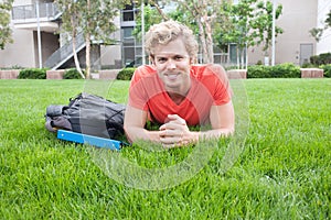 College student lying in the grass