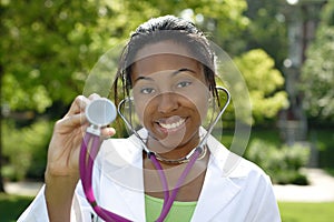 Beautiful female African American college student on campus wearing whitecoat