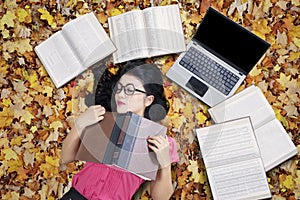 College Student Sleeping on The Autumn Leaves