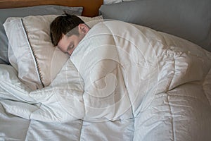 Young man sleeping photo