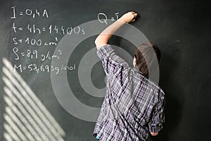 College student solving a math problem during math class