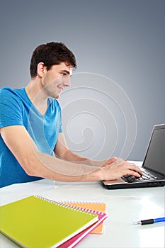 College student using his laptop computer