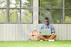 College Student Using Laptop Outdoors