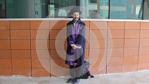A college student wearing a graduation gown
