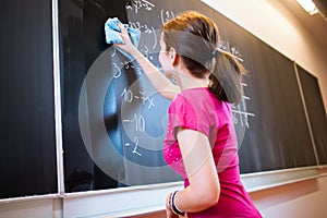 College student writing on the chalkboard